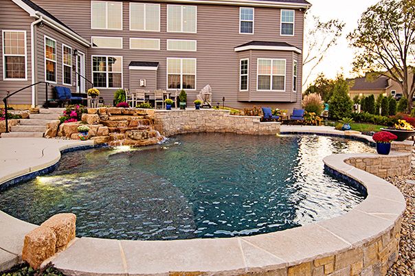 Pool With Fire Bowls and Boulder Waterfall