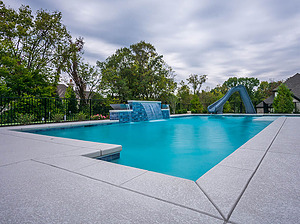 st louis pool construction, custom concrete pool, geometric, raised wall, sheer descent, water slide, textured deck