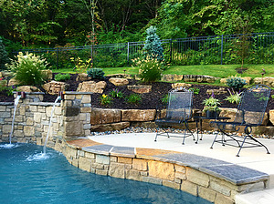 st louis pool construction, custom concrete pool, raised wall, scupper, flagstone coping
