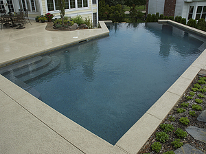 st louis pool construction, custom concrete pool, pebble finish, vanishing edge