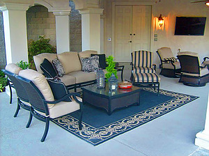 st. louis pool construction, black outdoor furniture with plush tan cushions, area rug, entertainment system 