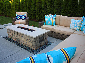 st. louis pool construction, brown wicker outdoor furniture with ivory cushions and blue pillows, fire pit