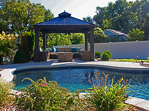 st. louis pool construction, brown wicker outdoor furniture with tan cushions, gazebo, fire table