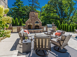 st. louis pool construction, wooden outdoor furniture with plush tan cushions, fireplace