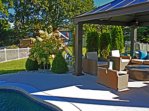 st. louis pool construction, brown wicker outdoor furniture with tan cushions, fire table, gazebo
