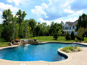 st. louis custom designed freeform concrete pool with raised wall, sheer descent and fire bowls
