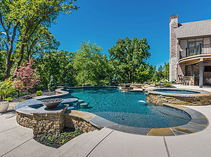 st. louis custom designed freeform concrete pool with raised spa, raised wall and fire water bowls