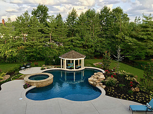 st. louis custom designed freeform concrete pool with boulder water feature, raised spa and gazebo structure