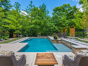 st. louis custom designed geometric concrete pool with raised wall, stepping stone pathway and seating areas