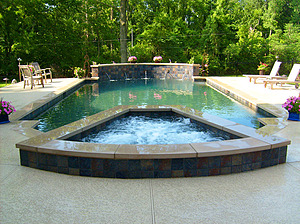 st. louis custom designed grecian concrete pool with raised wall, medallions and raised concrete spa
