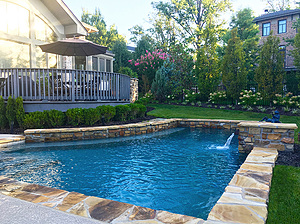 st. louis custom designed concrete pool with flagstone coping, raised wall and scuppers