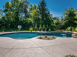 st. louis custom designed freeform concrete pool, basketball hoop, cantilever coping, sheer descent, green patio furniture