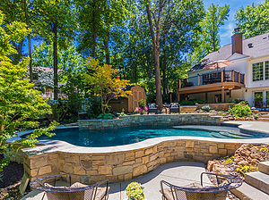 heavily shaded freeform st. louis custom designed concrete pool with raised wall