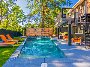 geometric st. louis custom designed concrete pool with sheer descent, wooden privacy fence and yellow patio furniture and lounge chairs