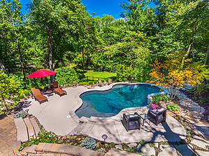 sunken patio with freeform st. louis custom designed concrete pool, heavily wooded surroundings