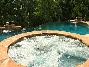 st. louis custom designed freeform concrete pool, raised spa with flagstone cap