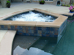 st. louis custom designed concrete pool, raised concrete spa with tile veneer and limestone coping