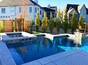 st. louis custom designed geometric concrete pool, rectangular raised spa with stone veneer, textured concrete coping and spillover feature
