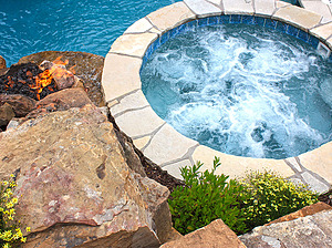 raised concrete spa with flagstone cap, boulder water feature with inset fire feature