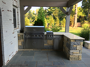 bluestone paver patio, outdoor kitchen with stone veneer and grill