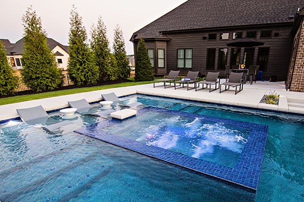 Pool With Perimeter Overflow Spa, Bubblers, and Sunken Swim-Up Bar