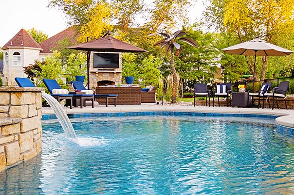 Pool With Jump Board and Raised Wall With Sheer Descent Waterfall