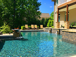 st louis pool construction, custom concrete pool, pebble finish, scupper, water bowl, fire bowl