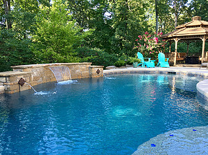 st louis pool construction, custom concrete pool, raised wall, sheer descent, pebble finish