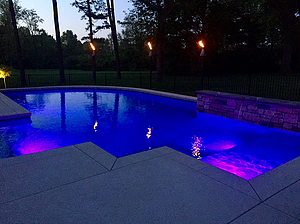 st louis pool construction, custom concrete pool, textured deck, lighting, tiki torch