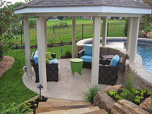 st. louis pool construction, checkered outdoor furniture with blue cushions, green pillows and table