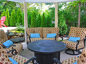 st. louis pool construction, black outdoor furniture with tan and red cushions, blue pillows