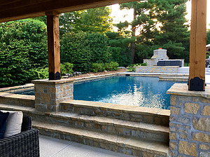 Flagstone steps leading up to geometric St. Louis custom designed concrete pool