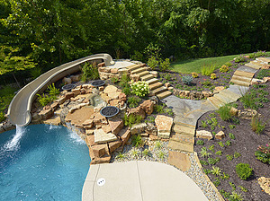 Shawnee ledgerock steps leading to top of fiberglass slide and down to pool area