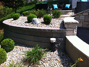 Modular block retaining wall with gravel planting beds