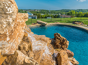 st. louis custom designed freeform concrete pool with jump rock and boulder water feature