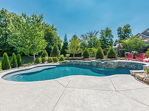 st. louis custom designed freeform concrete pool with raised wall, raised concrete spa and red patio furniture