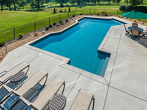 st. louis custom designed geometric concrete pool with cantilver coping, gravel planting beds and lounge chairs
