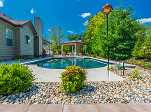 st. louis custom designed grecian concrete pool with gazebo structure, tiki torches and gravel planting beds
