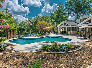 st. louis custom designed freeform concrete pool with covered seating areas, fire pit, wood privacy panels and gravel planting beds