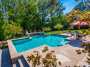 st. louis custom designed concrete pool with sheer descent and flagstone patio