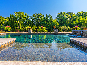 st. louis custom designed concrete pool with tanning shelf, fire bowls, raised pool wall and multiple scuppers