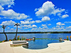 st. louis custom designed concrete pool, vanishing edge overlooking lake, laminar jets, palm trees