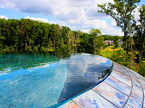 st. louis custom designed concrete pool, tiled vanishing edge overlooking trees