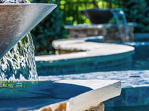 St. Louis custom designed freeform concrete pool with flagstone coping and two water fire bowls