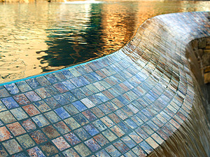 St. Louis custom designed freeform concrete pool with tiled vanishing edge