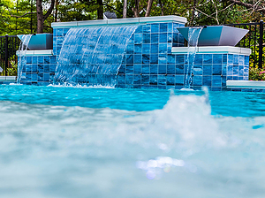 St. Louis custom designed concrete pool with bubbler fountain and raised tiled wall with sheer descent and two water bowls