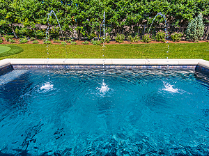 St. Louis custom designed geometric concrete pool with cast stone coping and three water crystal jets