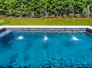 St. Louis custom designed geometric concrete pool with cast stone coping and three water crystal jets