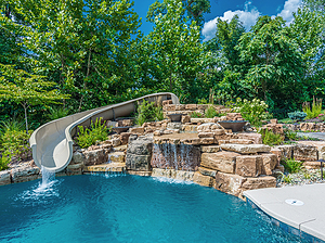 St. Louis custom designed freeform concrete pool and large boulder water feature, slide and fire bowls