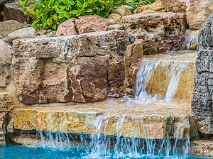 St. Louis custom designed concrete pool with large boulder water feature